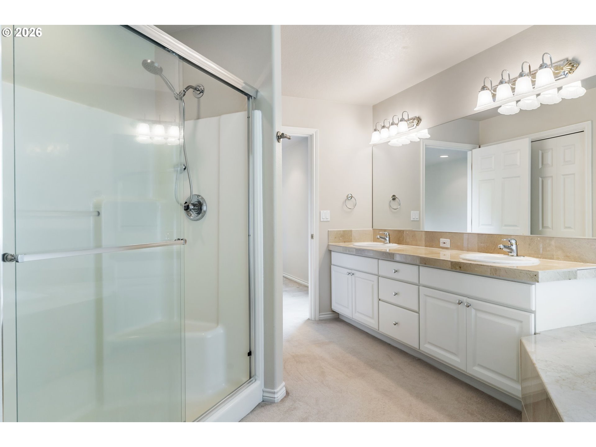 9907 Northwest Bartholomew Drive Portland, OR 97229 - Photo 23 of 37 a spacious bathroom with a double vanity sink mirror and shower