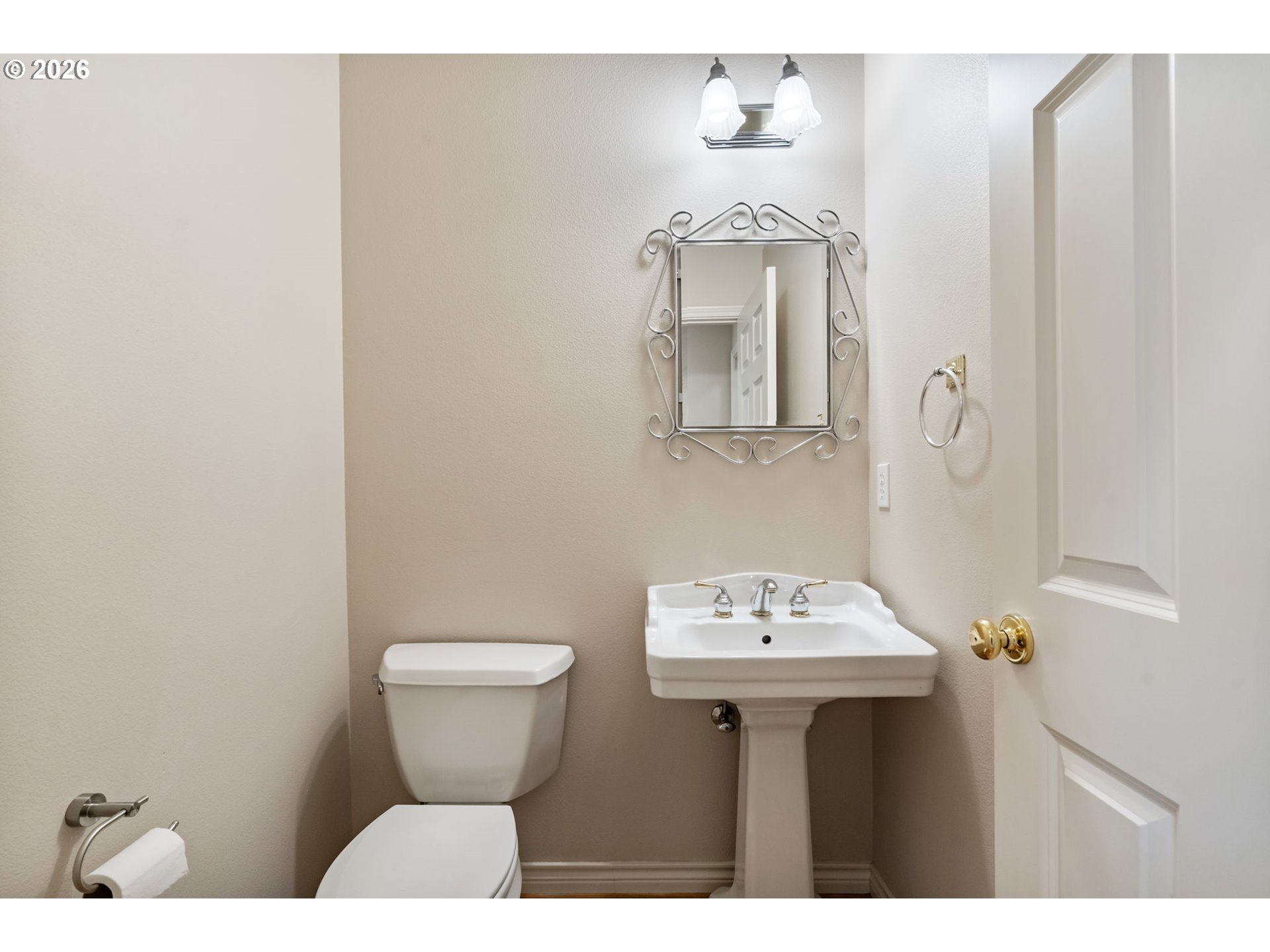 9907 Northwest Bartholomew Drive Portland, OR 97229 - Photo 7 of 37 a bathroom with a sink a toilet and mirror