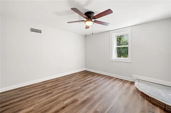 wooden floor in an empty room with a window