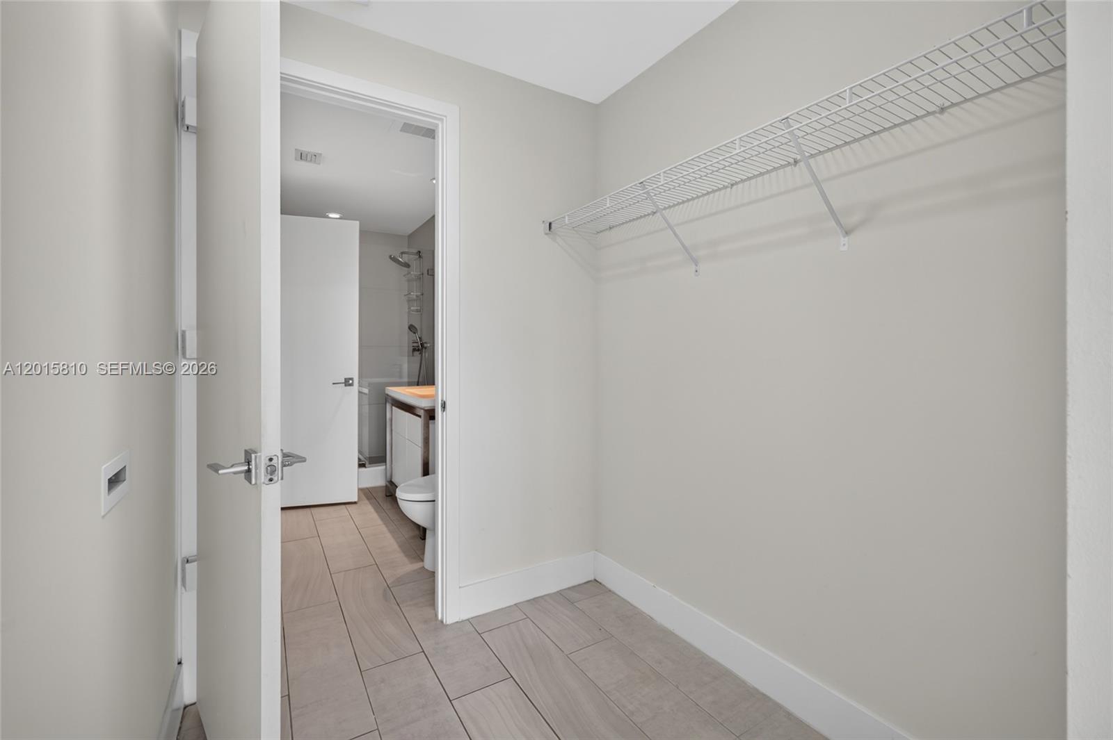 2000 Metropica Way, Unit 1902 Sunrise, FL 33323 - Photo 26 of 40 a view of a hallway with wooden shelves