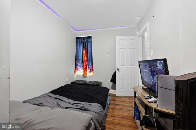 a bedroom with a bed and a television