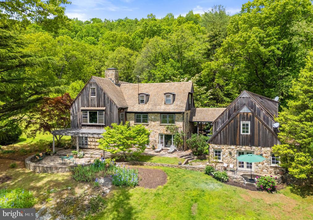 a view of a house with a yard and sitting area