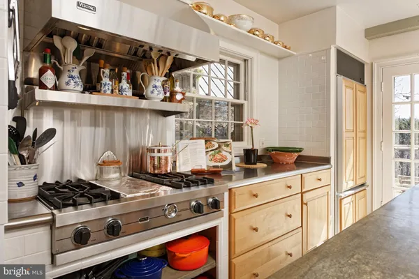 a kitchen with white cabinets and appliances