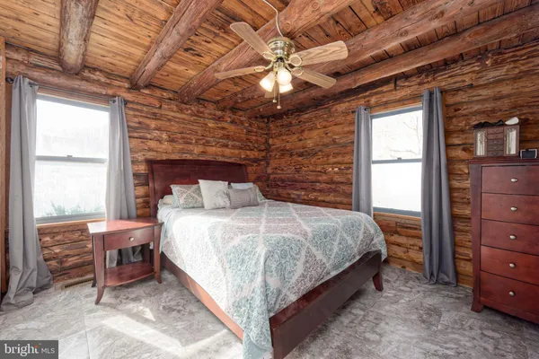 a bedroom with a bed and a painting on the wall