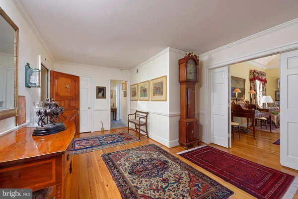 a living room with furniture rug and wooden floor