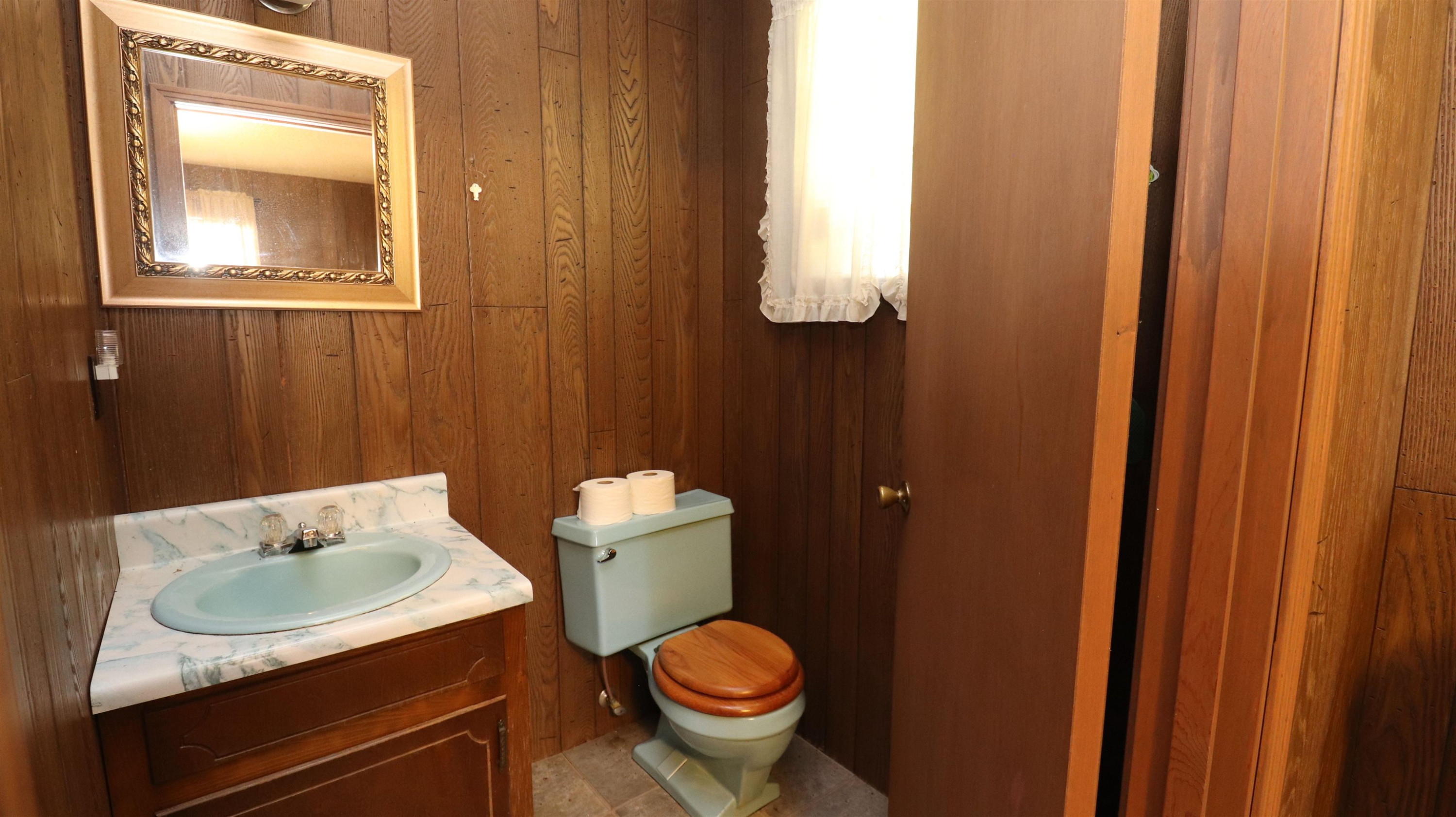 1040 Uptonville Road Mercer, TN 38392 - Photo 11 of 16 a bathroom with a granite countertop sink and a toilet