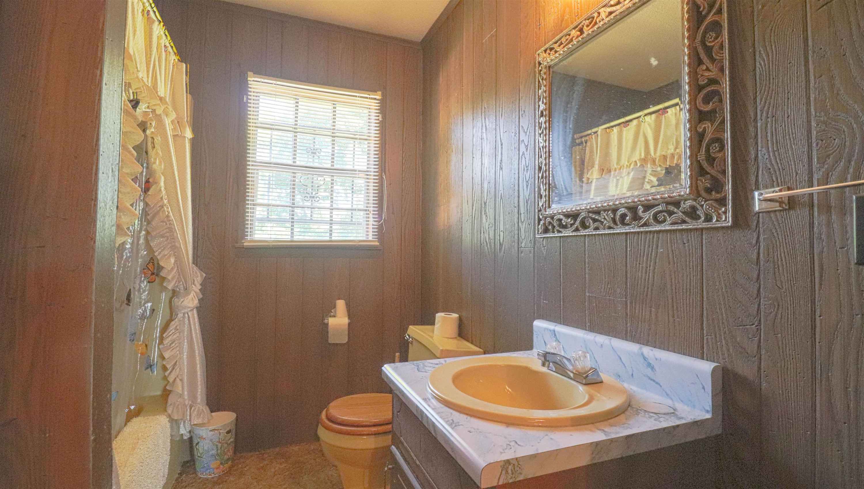 1040 Uptonville Road Mercer, TN 38392 - Photo 10 of 16 a bathroom with a sink toilet and mirror