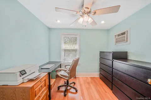 a workspace room with furniture and wooden floor
