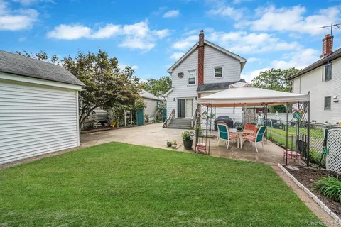 a view of a house with a yard and sitting area