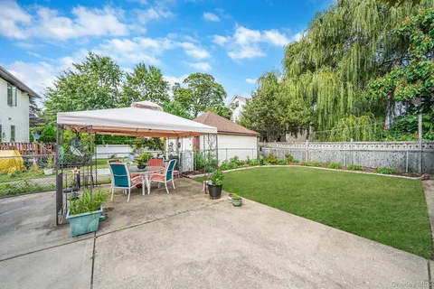 a view of backyard with outdoor seating and green space