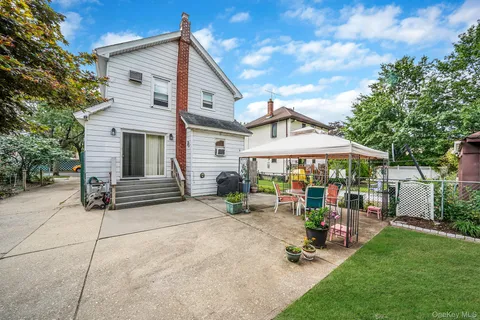 a view of a house with a yard porch and sitting area