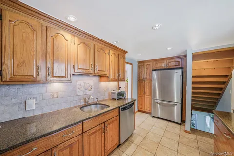 a kitchen with stainless steel appliances granite countertop a refrigerator sink and cabinets