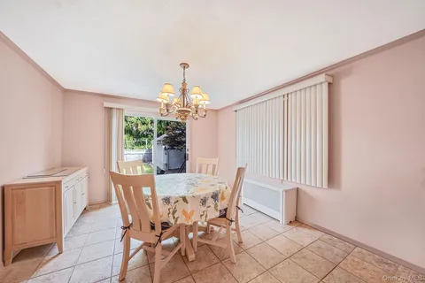 a view of a dining room with furniture and window