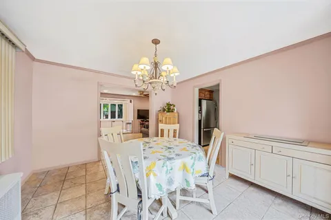 a view of a dining room with furniture and chandelier