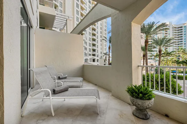 a living room with furniture and large windows