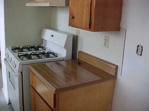 a kitchen with a stove and a refrigerator