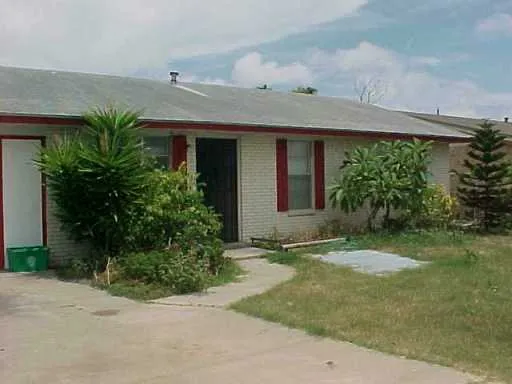 a view of a house with a yard and plants