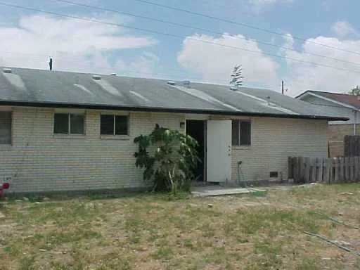 a view of a house with a backyard