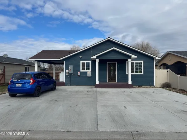 a front view of a house with parking space