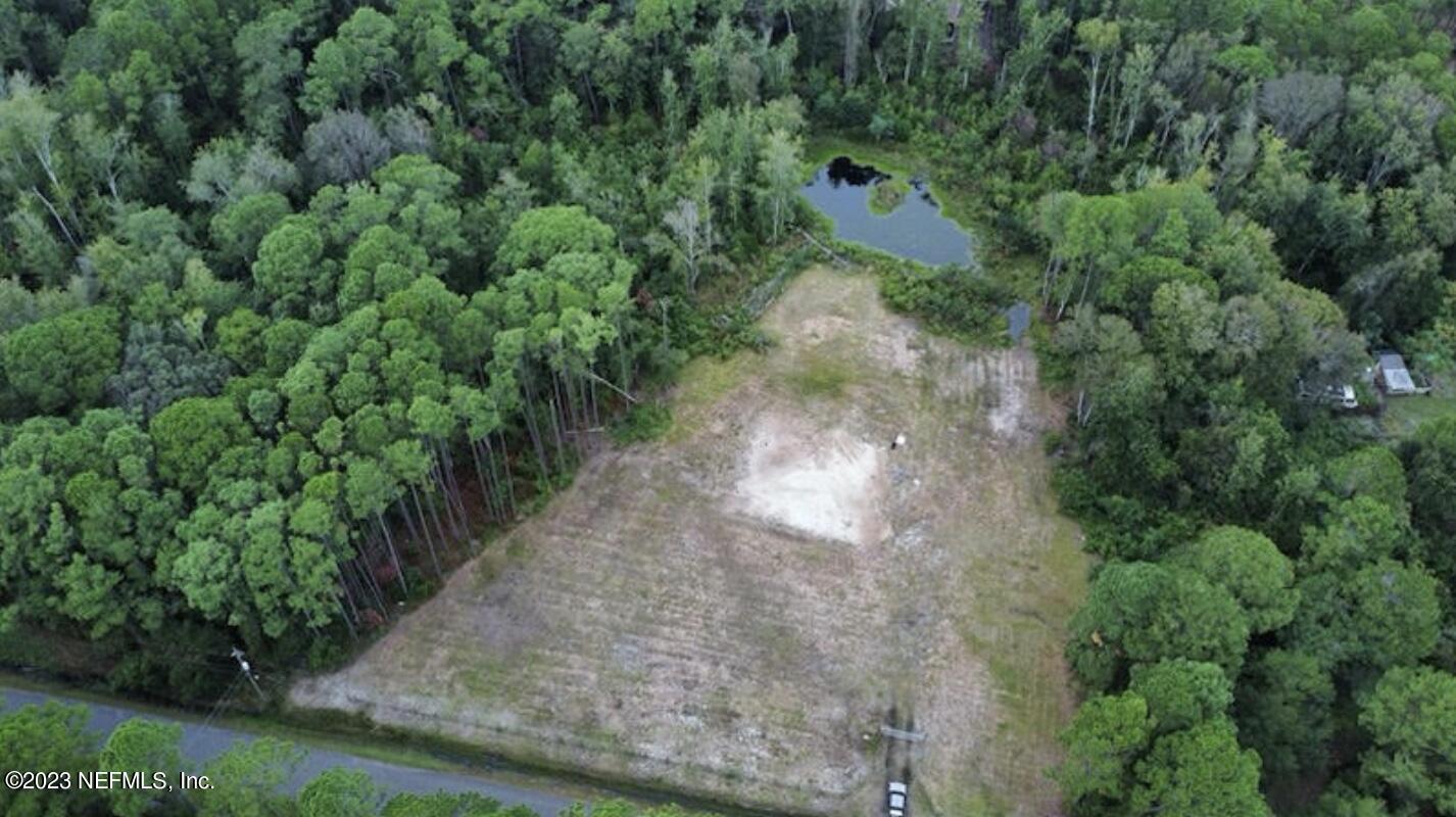 0 Croaker Road Jacksonville, FL 32226 - Photo 2 of 2 an aerial view of a house with a yard and trees all around