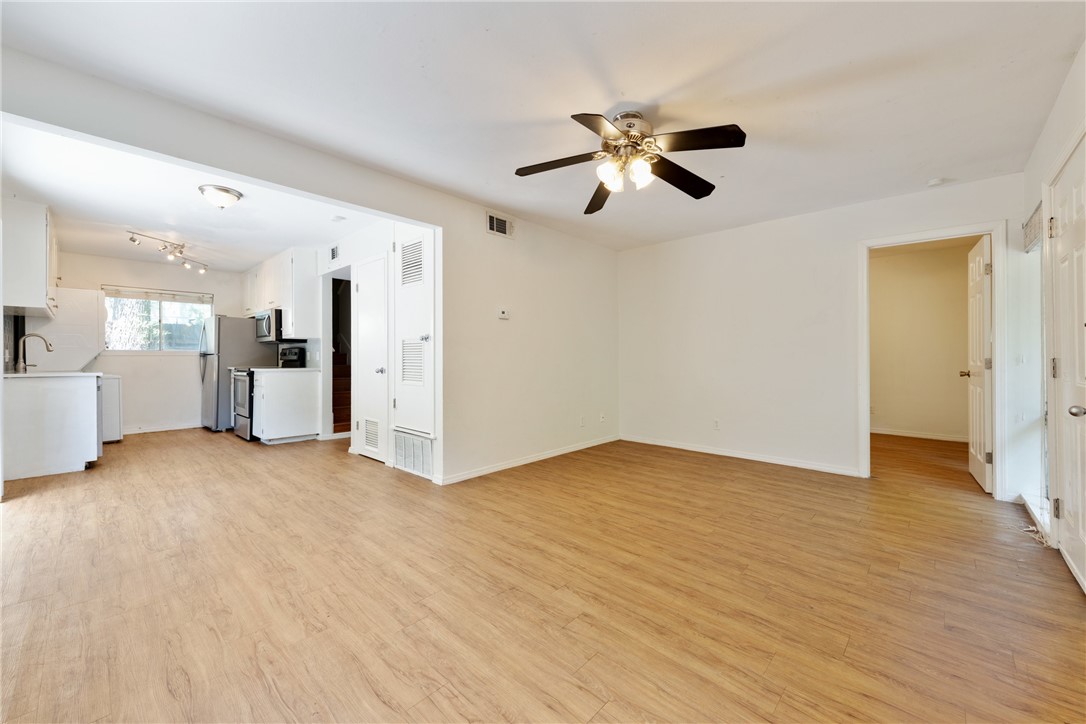 607 East 43rd Street, Unit A Austin, TX 78751 - Photo 1 of 26 a view of an empty room with wooden floor and a kitchen
