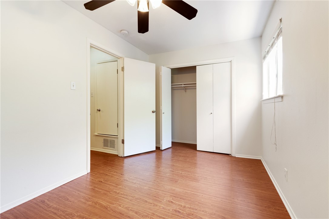 607 East 43rd Street, Unit A Austin, TX 78751 - Photo 11 of 26 an empty room with wooden floor and windows