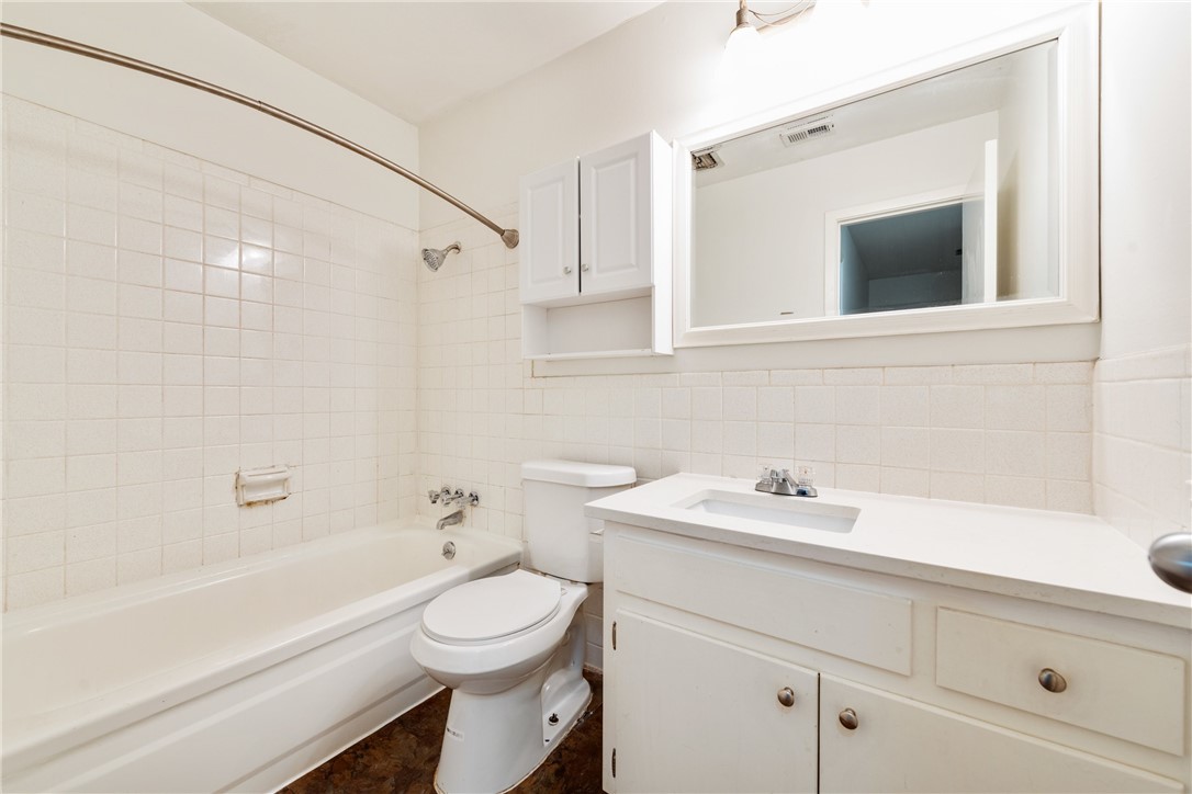 607 East 43rd Street, Unit A Austin, TX 78751 - Photo 12 of 26 a bathroom with a sink a toilet and shower