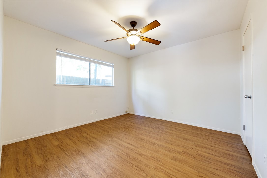 607 East 43rd Street, Unit A Austin, TX 78751 - Photo 14 of 26 a view of an empty room with wooden floor and a ceiling fan