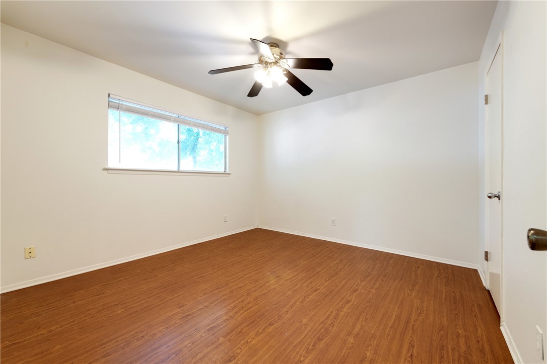 607 East 43rd Street, Unit A Austin, TX 78751 - Photo 15 of 26 an empty room with wooden floor ceiling fan and windows