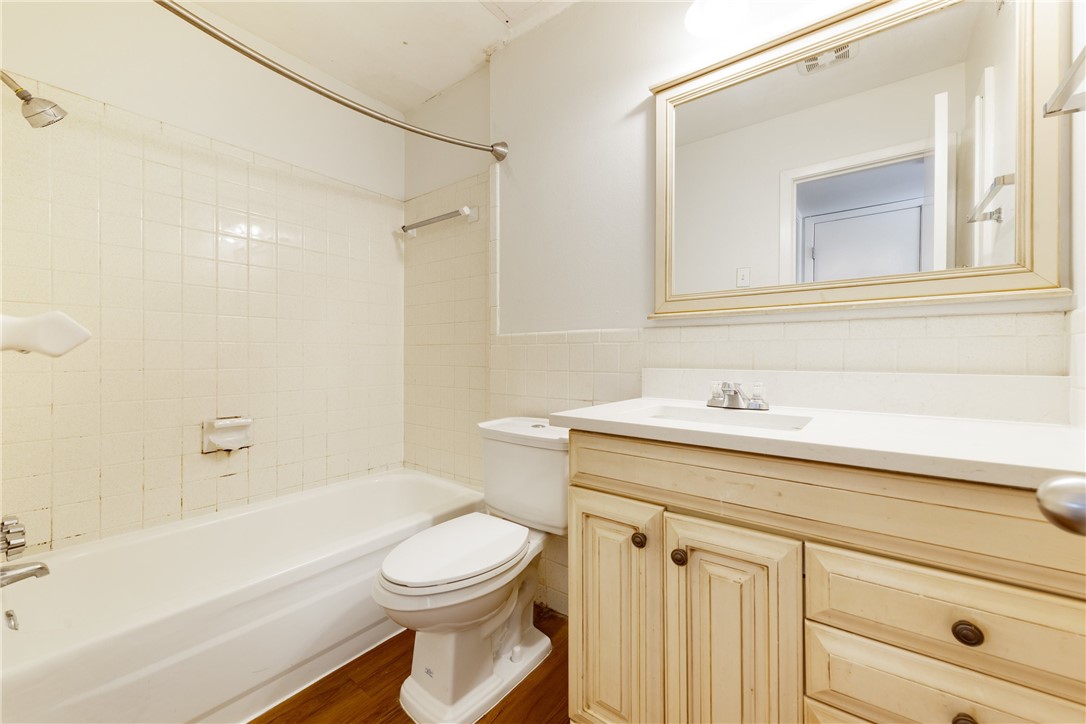 607 East 43rd Street, Unit A Austin, TX 78751 - Photo 16 of 26 a bathroom with a sink a toilet and shower
