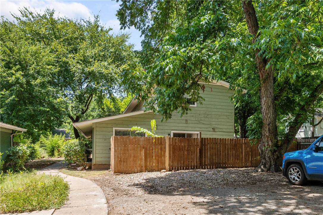 607 East 43rd Street, Unit A Austin, TX 78751 - Photo 24 of 26 a front view of a house with a yard and garage