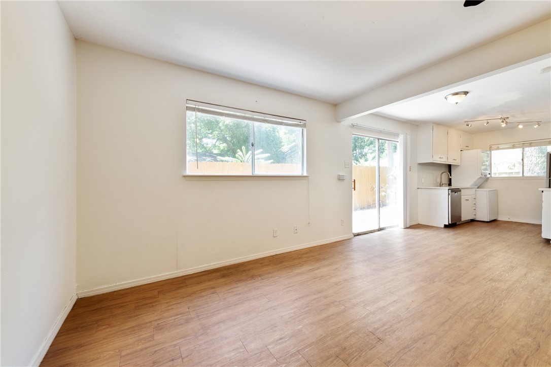 607 East 43rd Street, Unit A Austin, TX 78751 - Photo 5 of 26 an empty room with wooden floor and windows