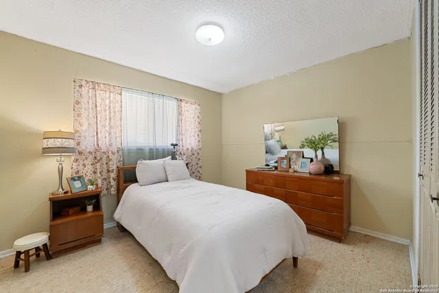 a bedroom with a bed and a dresser in it