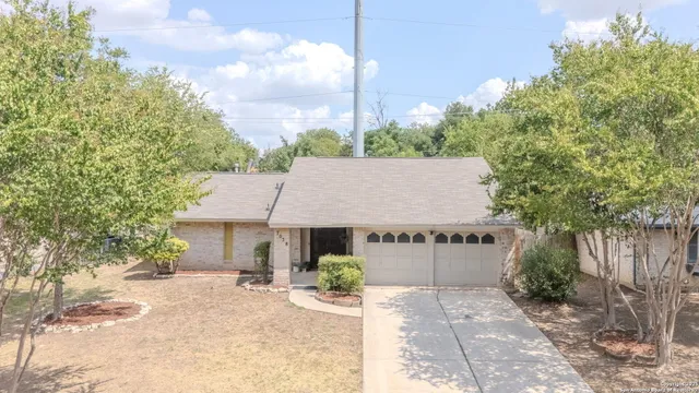 a view of a house with a yard and sitting area