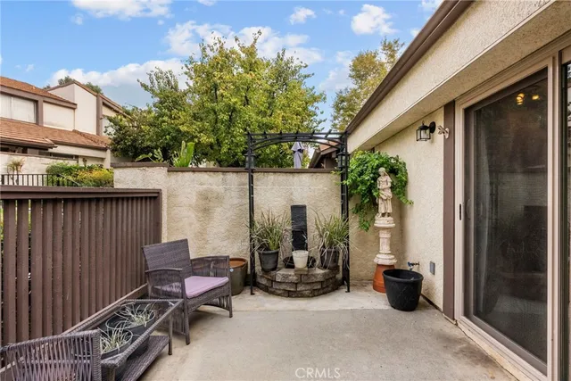 a view of backyard with outdoor seating and plants