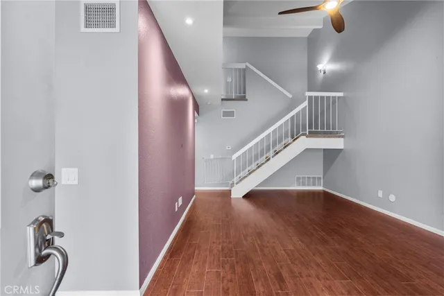 a view of entryway and hall with wooden floor