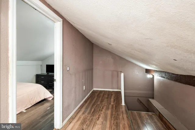 a bedroom with a bed tv and a desk