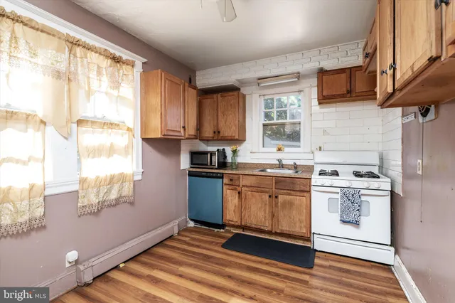 a kitchen with stainless steel appliances granite countertop a sink and a stove