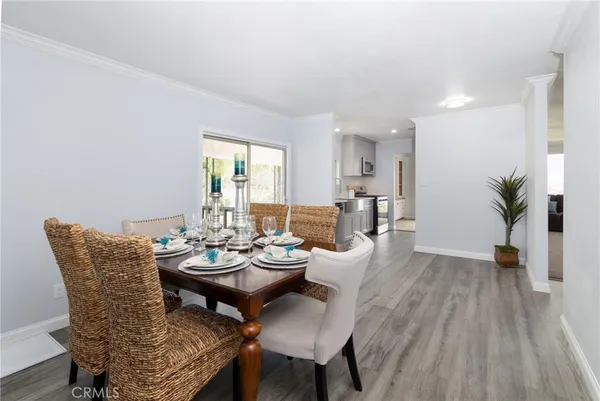 a view of a dining room with furniture and wooden floor