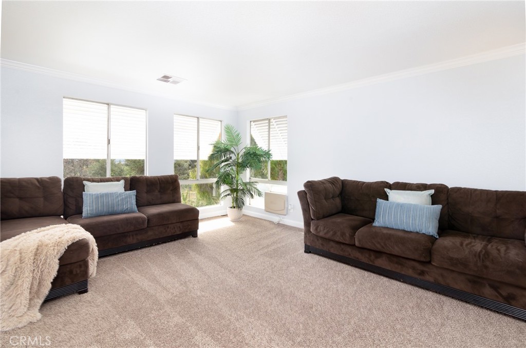 24363 Briggs Road Menifee, CA 92585 - Photo 11 of 43 a living room with furniture and a large window