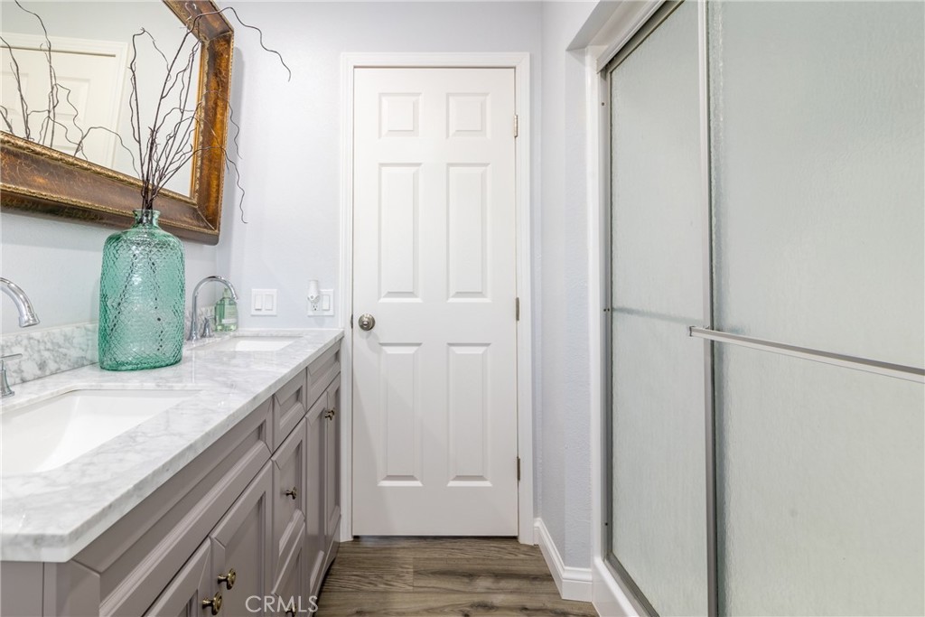 24363 Briggs Road Menifee, CA 92585 - Photo 17 of 43 a bathroom with a granite countertop sink and a mirror