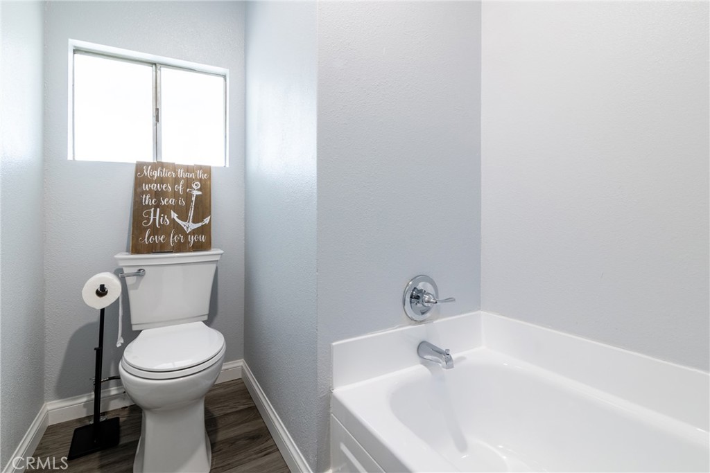 24363 Briggs Road Menifee, CA 92585 - Photo 23 of 43 a bathroom with a toilet and a bathtub