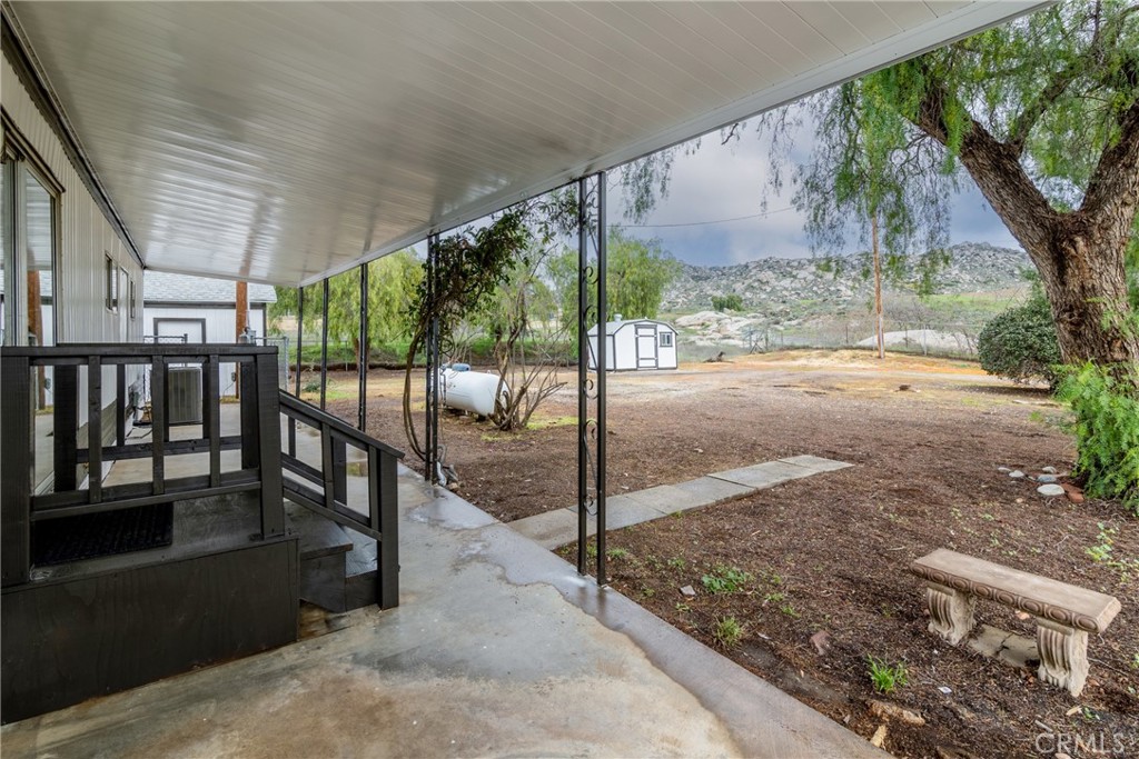 24363 Briggs Road Menifee, CA 92585 - Photo 26 of 43 a view of porch with a floor to ceiling window and wooden fence