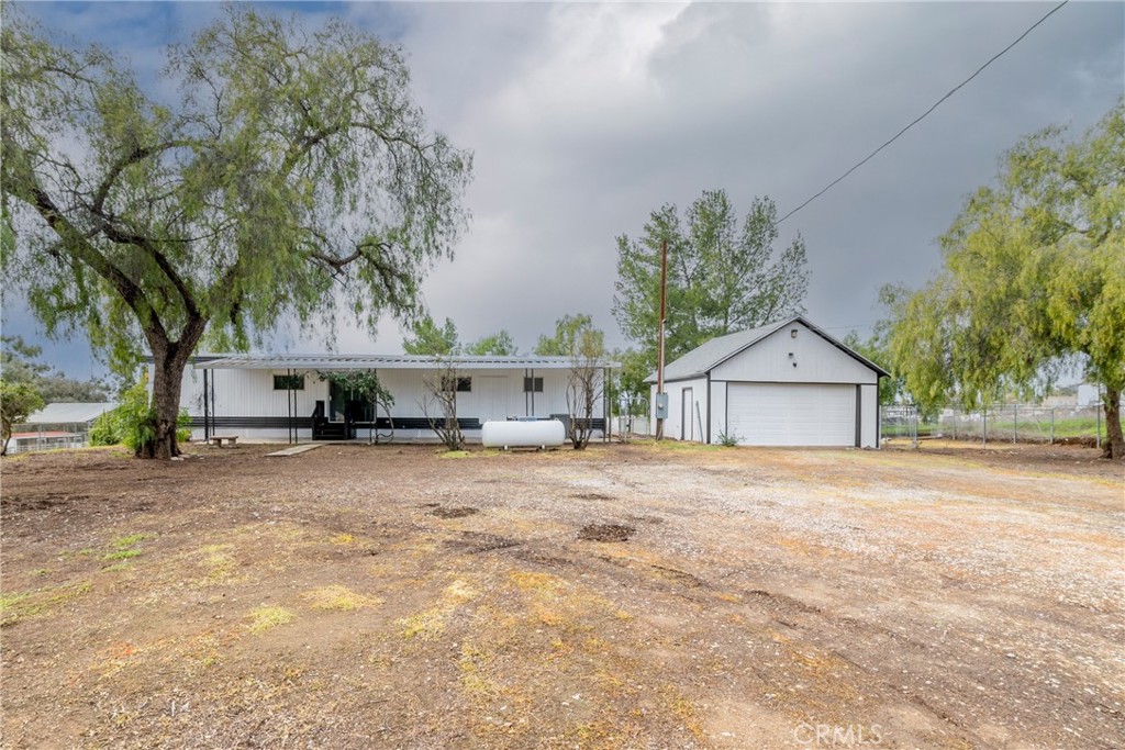 24363 Briggs Road Menifee, CA 92585 - Photo 29 of 43 a view of a house with a yard and garage