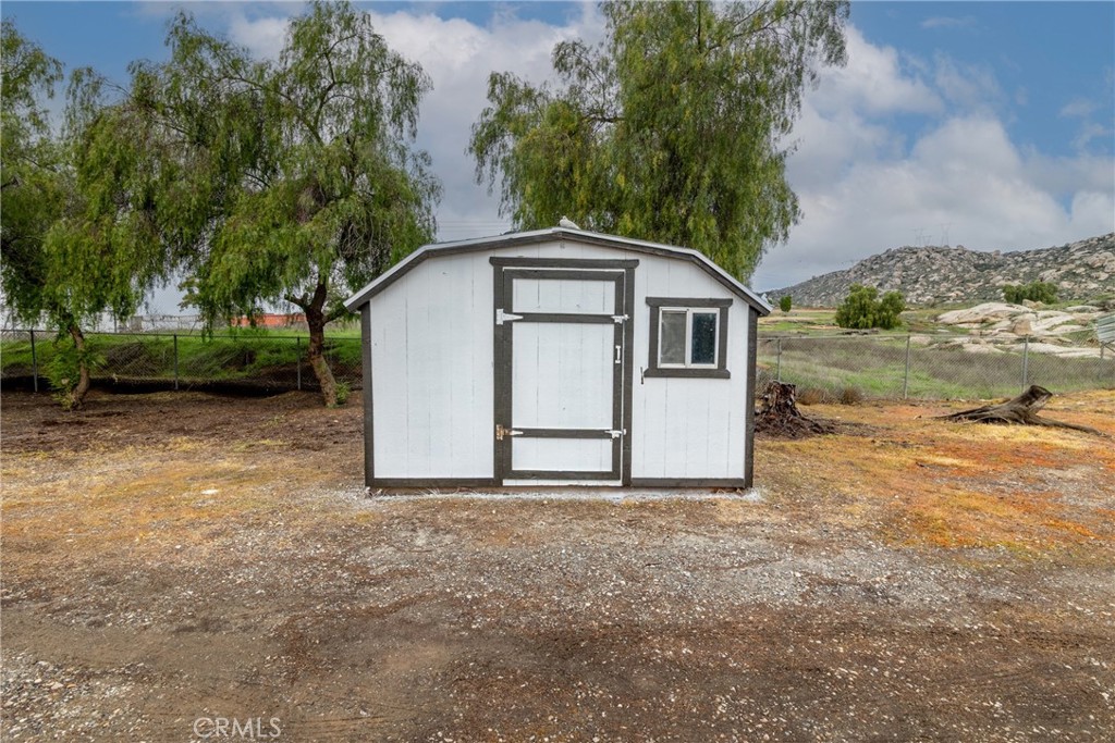 24363 Briggs Road Menifee, CA 92585 - Photo 30 of 43 a view of a house with a yard and large tree