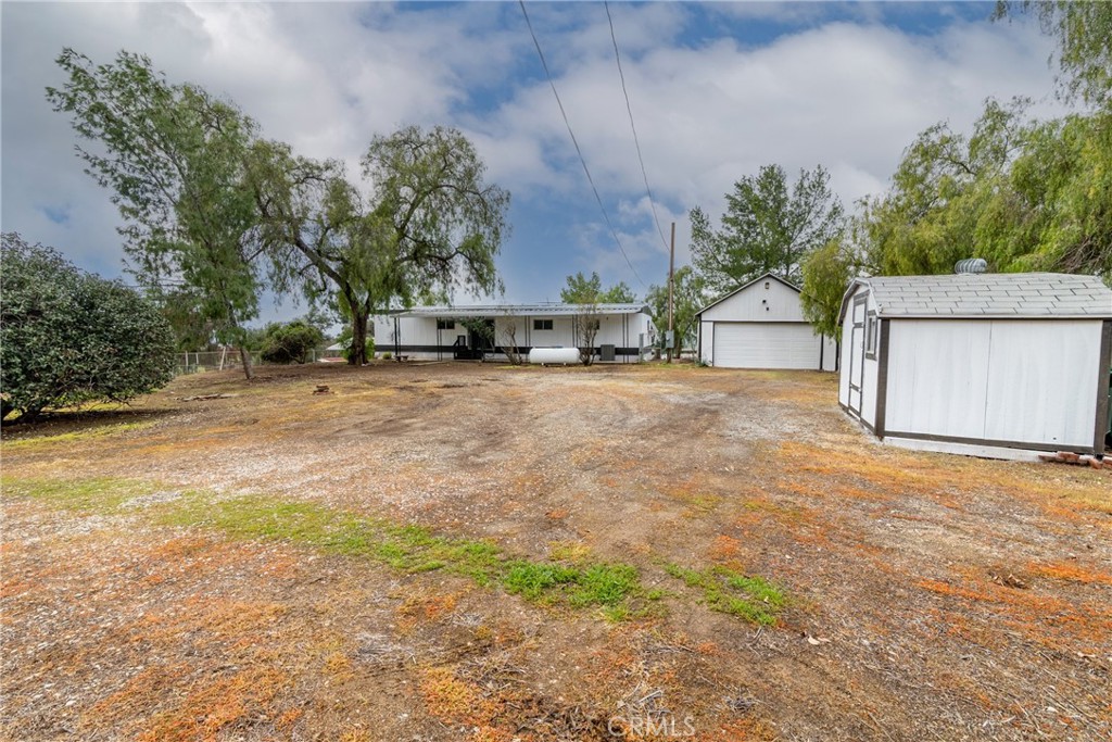 24363 Briggs Road Menifee, CA 92585 - Photo 31 of 43 a view of a house with a yard and garage