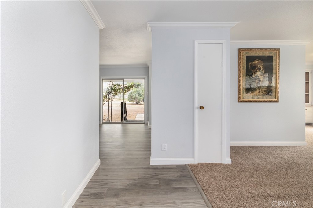 24363 Briggs Road Menifee, CA 92585 - Photo 7 of 43 a view of a hallway with wooden floor and a living room