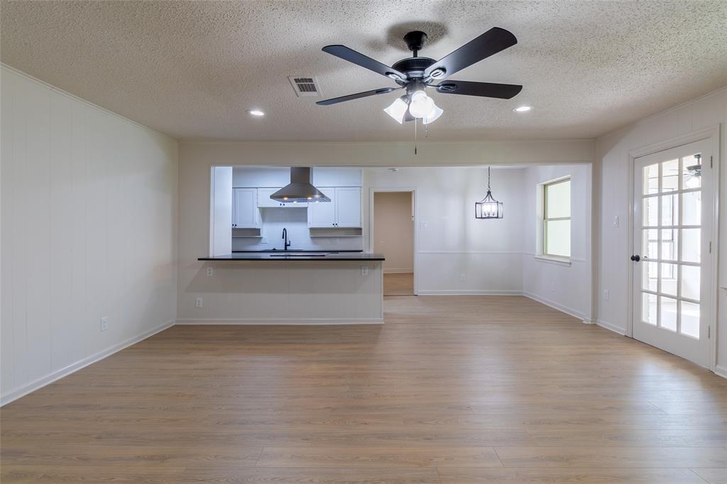 6192 Wrigley Way Fort Worth, TX 76133 - Photo 22 of 22 an empty room with wooden floor and windows