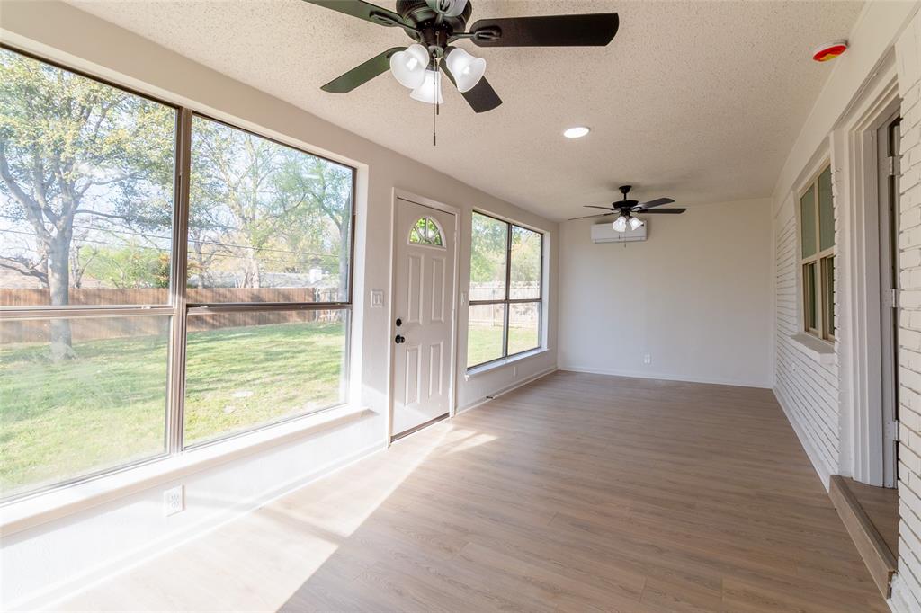 6192 Wrigley Way Fort Worth, TX 76133 - Photo 19 of 22 a view of an empty room with a window and a ceiling fan