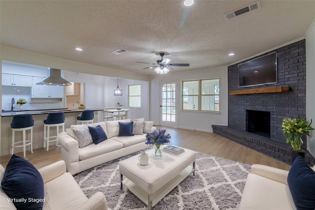 6192 Wrigley Way Fort Worth, TX 76133 - Photo 2 of 22 a living room with furniture and a fireplace